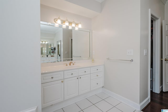 bathroom featuring vanity, tile patterned flooring, and crown molding