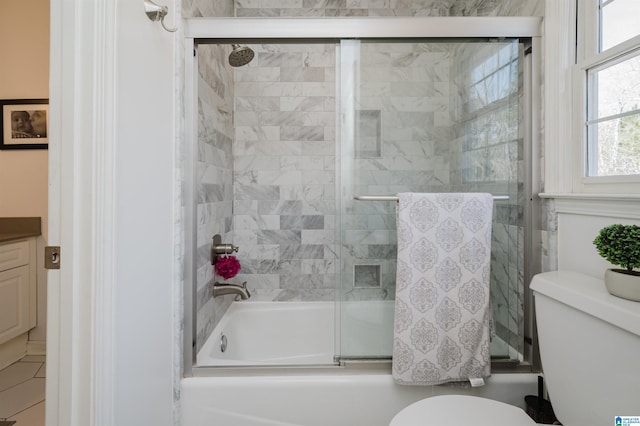 full bathroom featuring vanity, toilet, and combined bath / shower with glass door