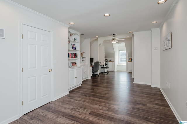 hallway featuring crown molding, dark hardwood / wood-style flooring, and built in shelves