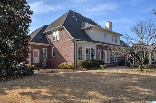 back of house with a yard