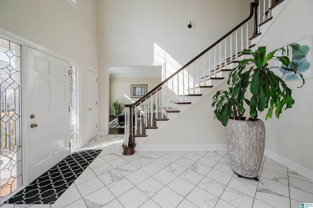 foyer featuring a towering ceiling