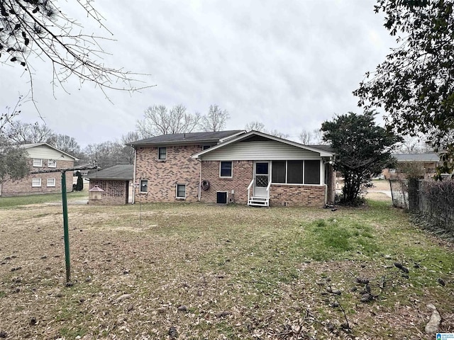 back of house with central air condition unit and a yard