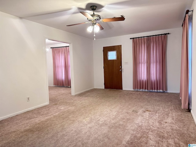 interior space with ceiling fan and light colored carpet