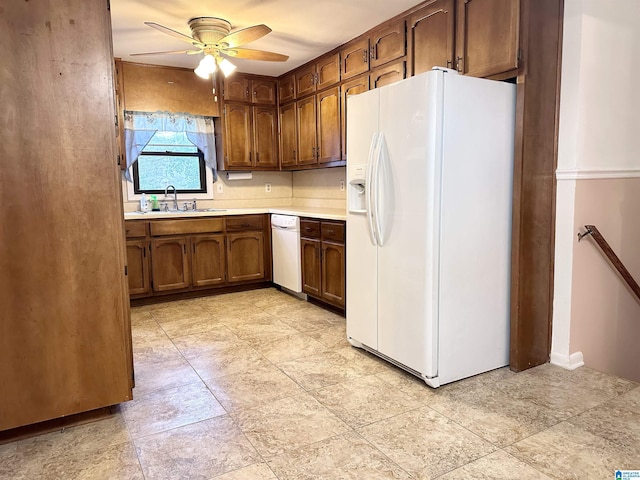 kitchen featuring white fridge with ice dispenser, ceiling fan, and sink