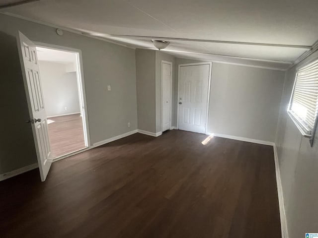 interior space with dark wood-style flooring and baseboards