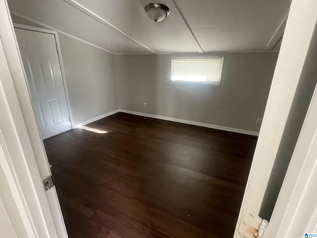 interior space featuring baseboards and dark wood finished floors