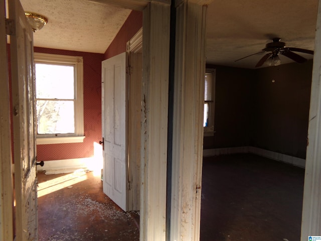 hall with a textured ceiling