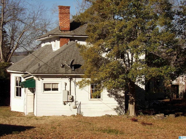 rear view of house with a lawn