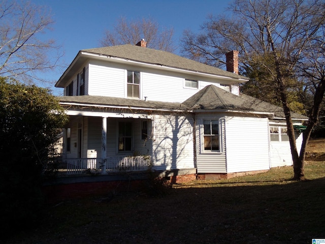 rear view of property with a porch