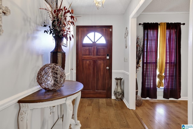 foyer featuring light hardwood / wood-style floors and a textured ceiling