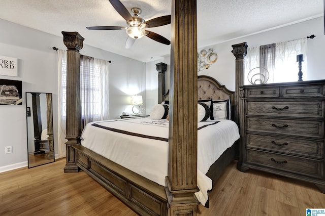 bedroom featuring ceiling fan, a textured ceiling, and light hardwood / wood-style flooring