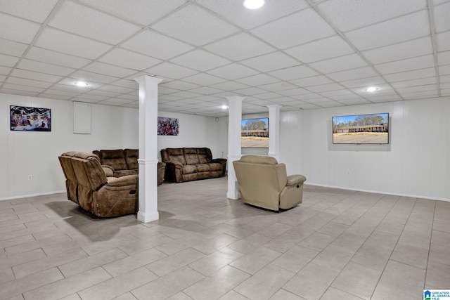 living room featuring decorative columns, a paneled ceiling, and light tile patterned floors