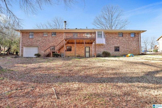 rear view of house featuring a garage, cooling unit, and a wooden deck