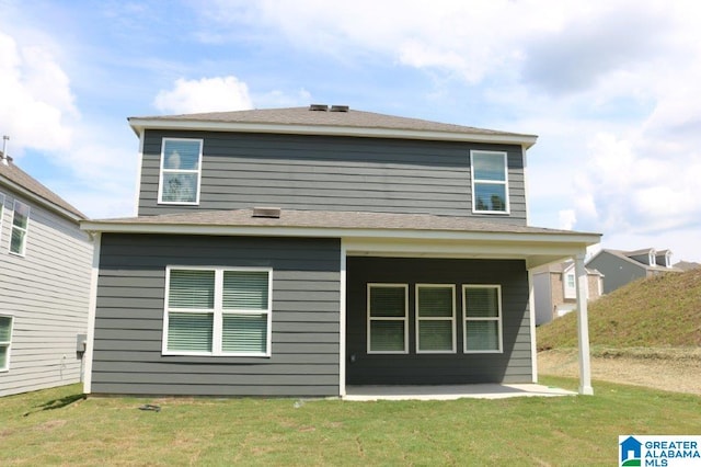 back of house with a patio and a lawn