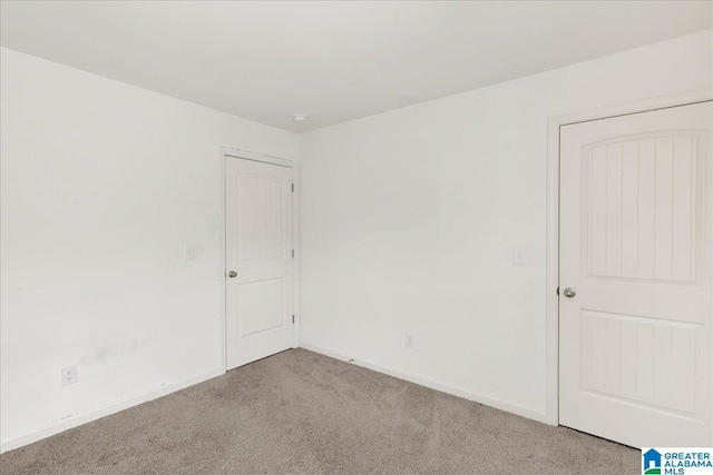 unfurnished room with light colored carpet