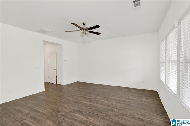 unfurnished room featuring ceiling fan, plenty of natural light, and dark hardwood / wood-style flooring