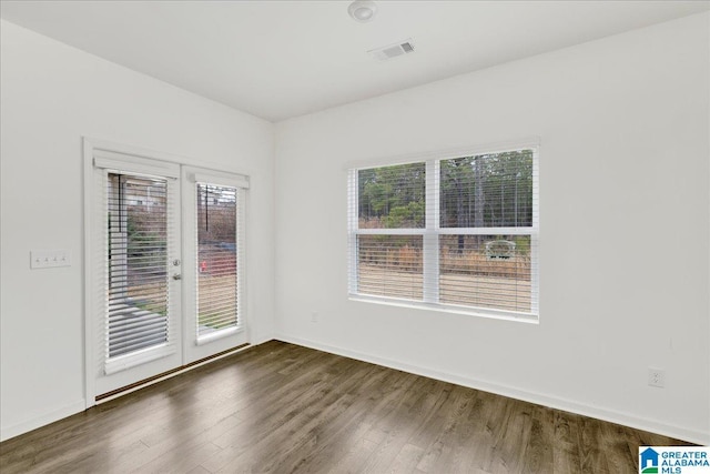 unfurnished room featuring dark hardwood / wood-style flooring and french doors