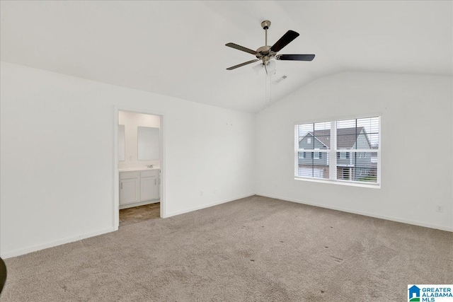 unfurnished bedroom with light carpet, connected bathroom, lofted ceiling, and ceiling fan