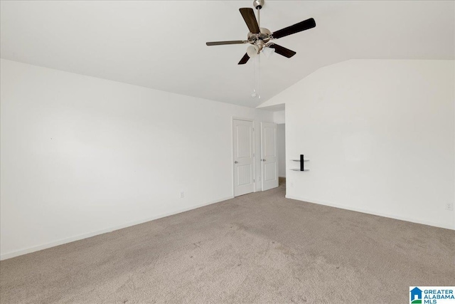 spare room with light carpet, lofted ceiling, and ceiling fan