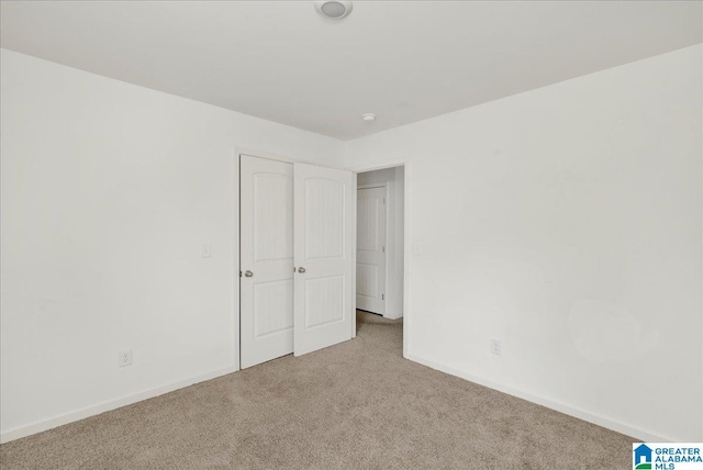 unfurnished bedroom with light colored carpet