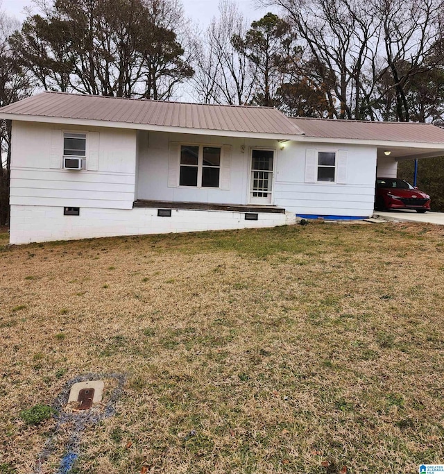 ranch-style home featuring cooling unit, a front yard, and a carport