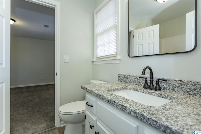 bathroom featuring vanity and toilet