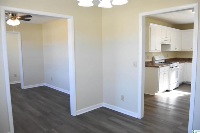 kitchen with white cabinets, white range with gas stovetop, and dark hardwood / wood-style flooring