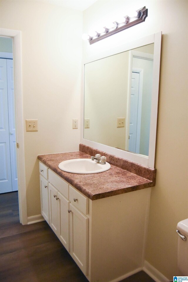 bathroom featuring hardwood / wood-style flooring and vanity