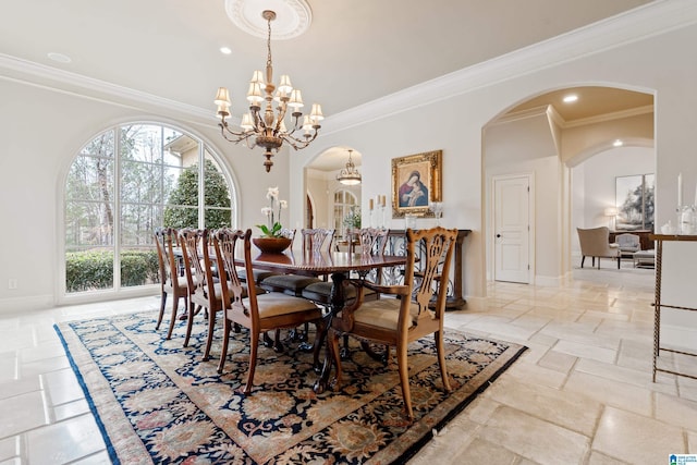 dining room with ornamental molding and a chandelier