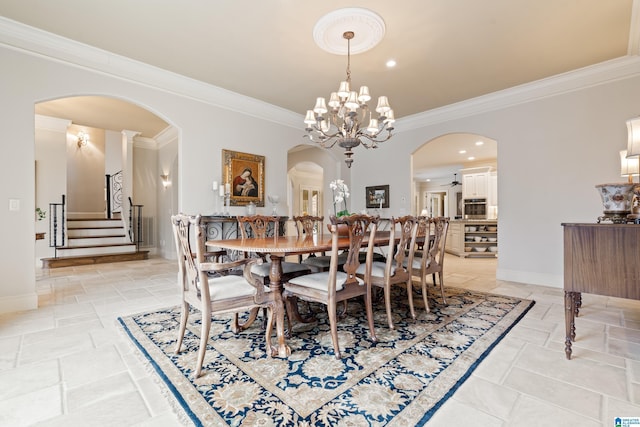 dining room with crown molding and ceiling fan with notable chandelier