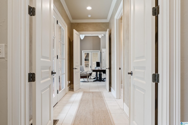 hall with light tile patterned floors, ornamental molding, and french doors