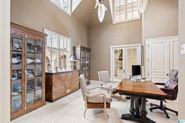 tiled office space with french doors and a high ceiling