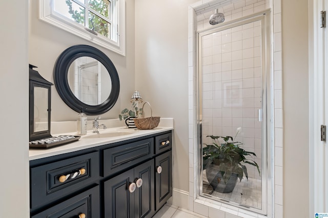 bathroom featuring tile patterned floors, an enclosed shower, and vanity