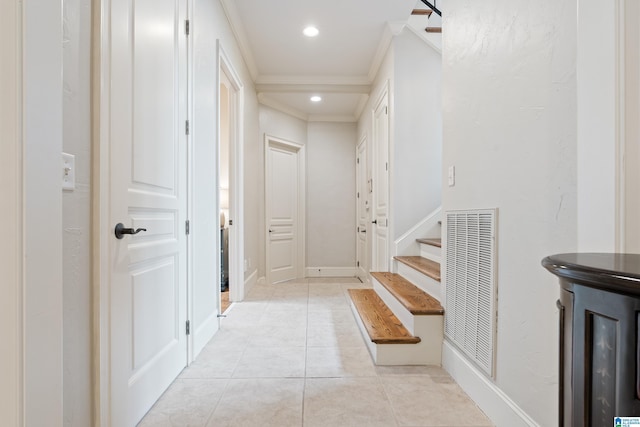 hallway featuring light tile patterned floors and ornamental molding