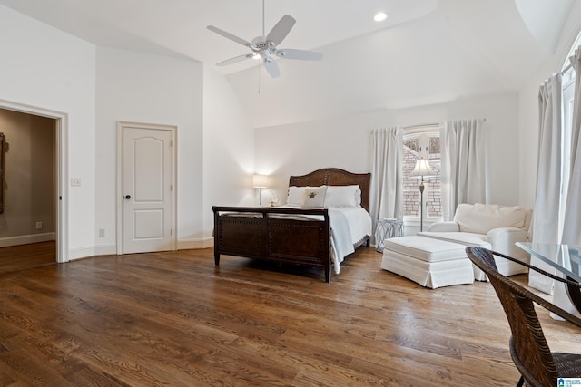 bedroom with ceiling fan, dark hardwood / wood-style flooring, and vaulted ceiling