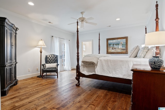 bedroom featuring ceiling fan, crown molding, and hardwood / wood-style floors