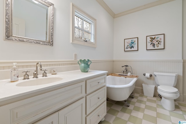 bathroom with toilet, a bath, crown molding, and vanity