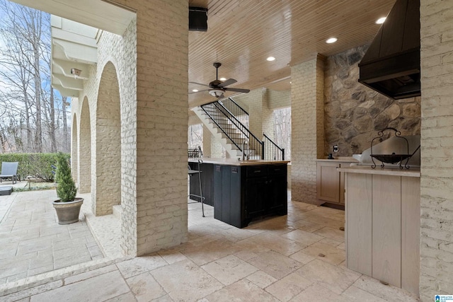 view of patio / terrace with ceiling fan, exterior bar, and an outdoor kitchen