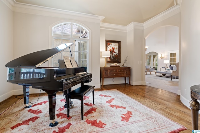 misc room featuring wood-type flooring and ornamental molding