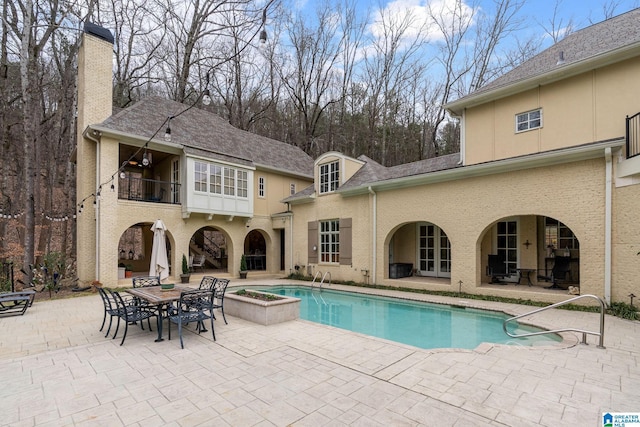 view of swimming pool featuring a patio area