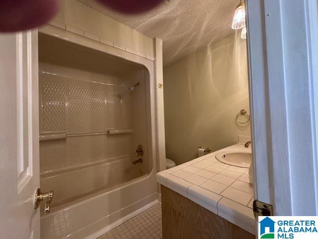 full bathroom featuring vanity, washtub / shower combination, and toilet