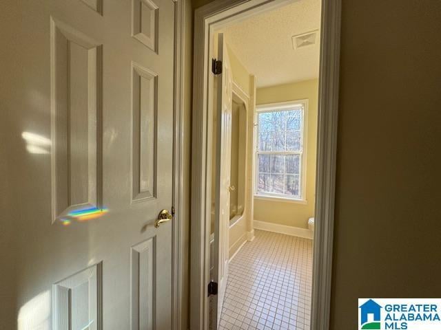 hall featuring tile patterned flooring