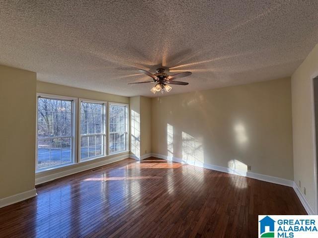 spare room featuring hardwood / wood-style floors, a textured ceiling, and ceiling fan