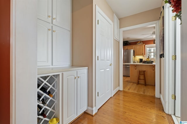 corridor with light hardwood / wood-style floors