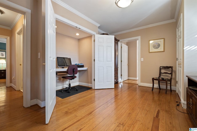 office area featuring crown molding and light hardwood / wood-style flooring