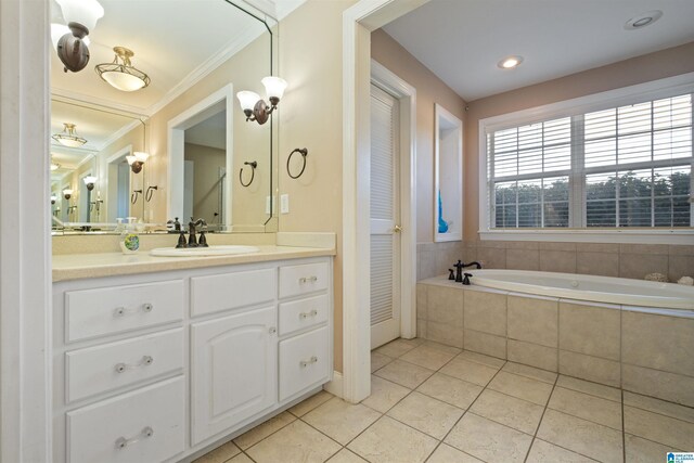 bathroom featuring tiled bath, vanity, ornamental molding, and tile patterned flooring