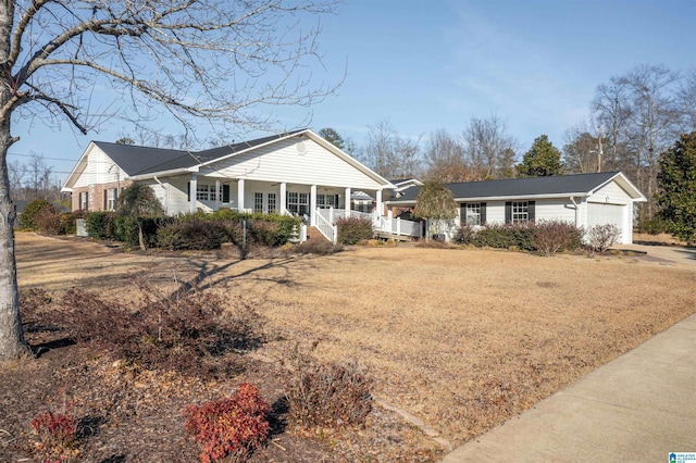 ranch-style home featuring covered porch and a front lawn