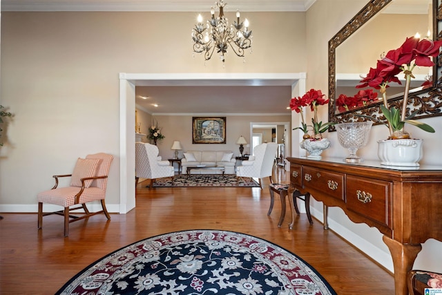 entryway featuring crown molding, hardwood / wood-style flooring, and a notable chandelier