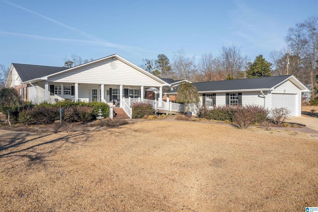 ranch-style home featuring a garage, covered porch, and a front lawn