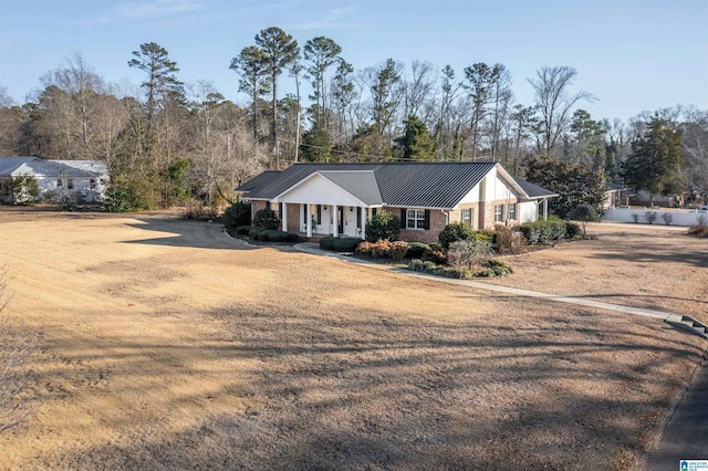 single story home featuring a front lawn and a porch